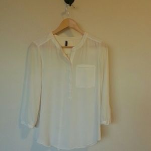 Semi-sheer cream blouse.